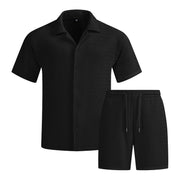 Ensemble vacances uni — noir présenté à plat, chemise col cubain et short