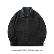 Veste noire à texture côtelée et col vert foncé, zippée de face, avec deux poches plaquées.