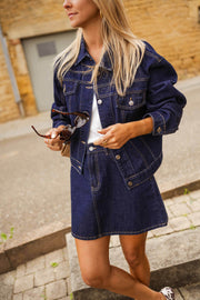 Veste en jean courte portée par une femme, vue de trois-quarts, rue, lunettes de soleil