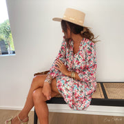 Robe fleurie à lurex portée par une femme, assise, banc, jambes croisées