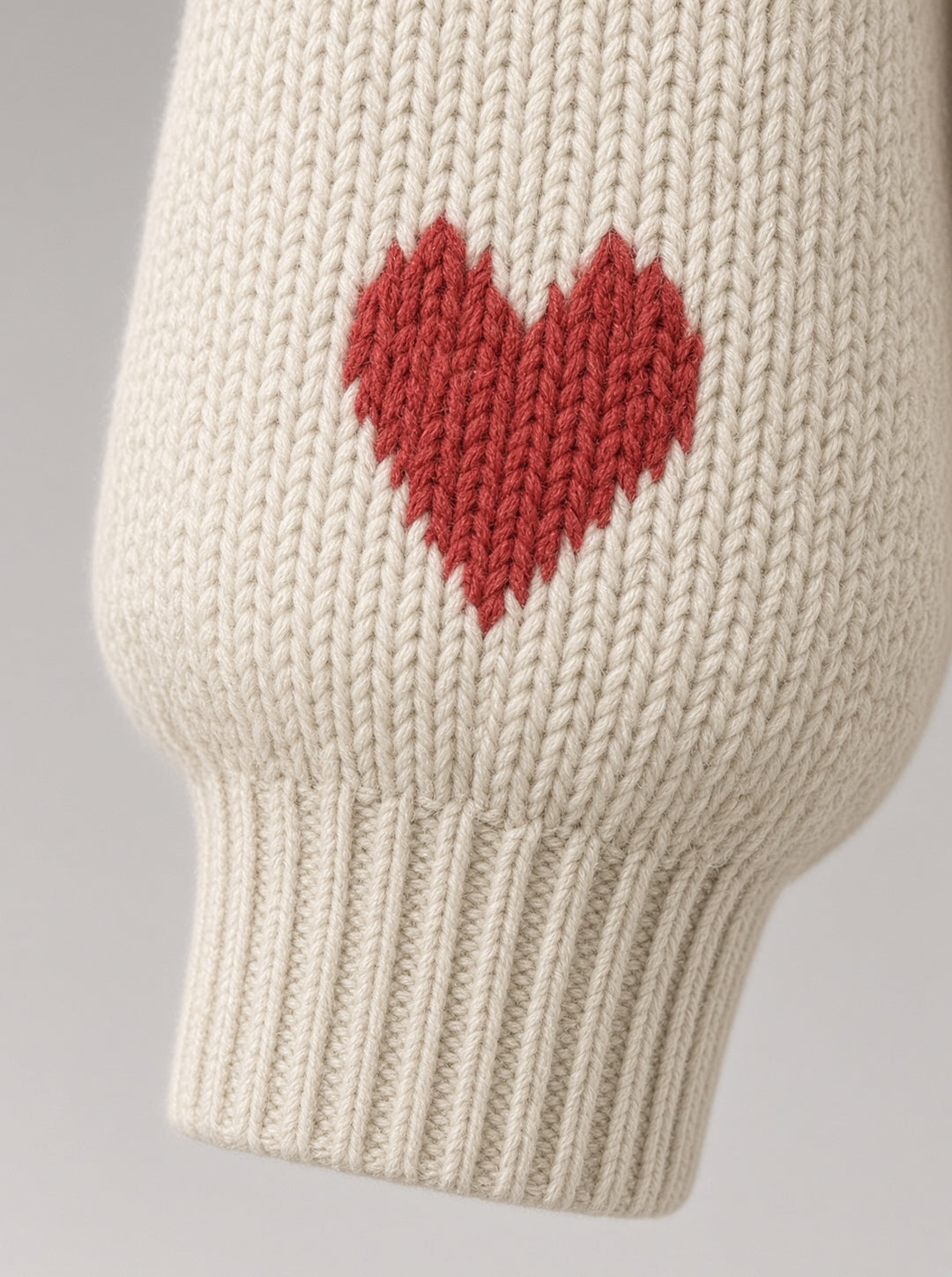 Cardigan long blanc cassé à cœurs rouges — détail du poignet côtelé
