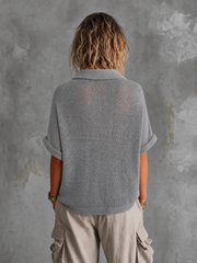 Pull gris col ouvert — vue portée de dos, cadrée au-dessus des genoux