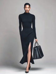 Robe longue noire à manches longues et fente haute, vue de face.