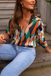 Chemise fluide à motifs multicolore portée par une femme, vue de face, marches, col ouvert