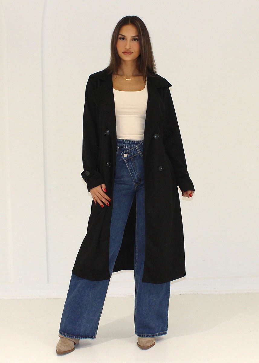 Manteau noir effet daim — vue portée en pied, ouvert sur un haut blanc et un jean