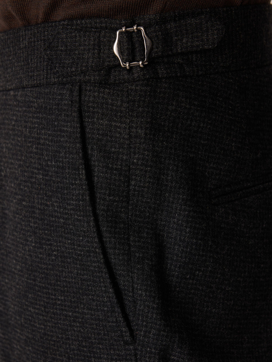 Pantalon slim anthracite à carreaux — détail de la patte de serrage