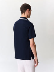 Polo maille bleu marine — vue portée de dos