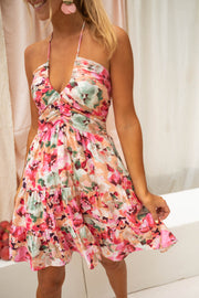 Robe fleurie courte décolleté V portée par une femme, vue rapprochée, décolleté V, jupe