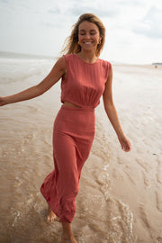 Robe longue col montant fendue portée par une femme, en marchant, eau, sourire