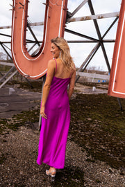 Robe fluide légèrement moulante portée par une femme, vue de dos, enseigne, cheveux blonds