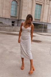 Robe rayée en coton moulante portée par une femme, vue de trois-quarts, cour, cheveux blonds