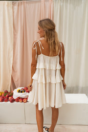 Robe courte à volants portée par une femme, vue de dos, volants, cheveux blonds