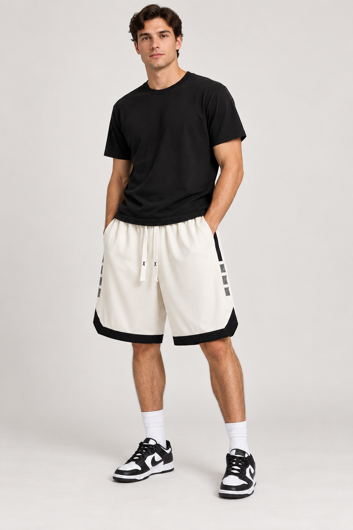 Modelo adulto com calções de basquetebol bege e preto, vista frontal.