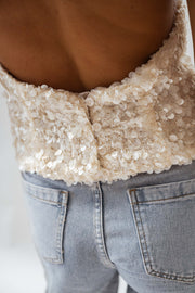 Top pailleté dos ouvert porté par une femme, vue rapprochée, paillettes, dos, ceinture du jean