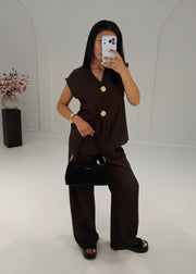 Ensemble brun à boutons dorés, vue de face avec pantalon large